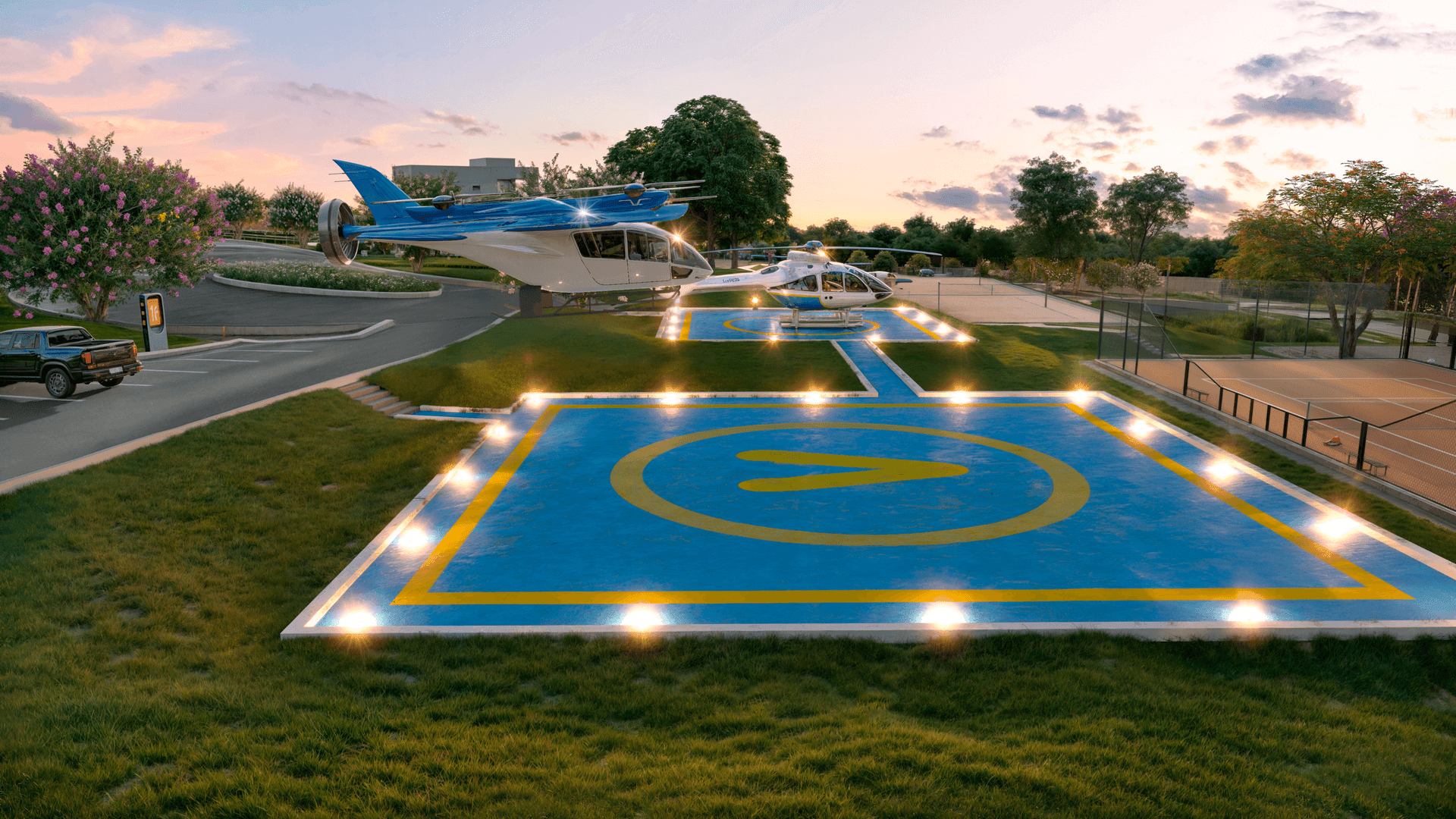 Two helicopters parked at illuminated landing pads during sunset, with surrounding greenery and a vehicle parked nearby.