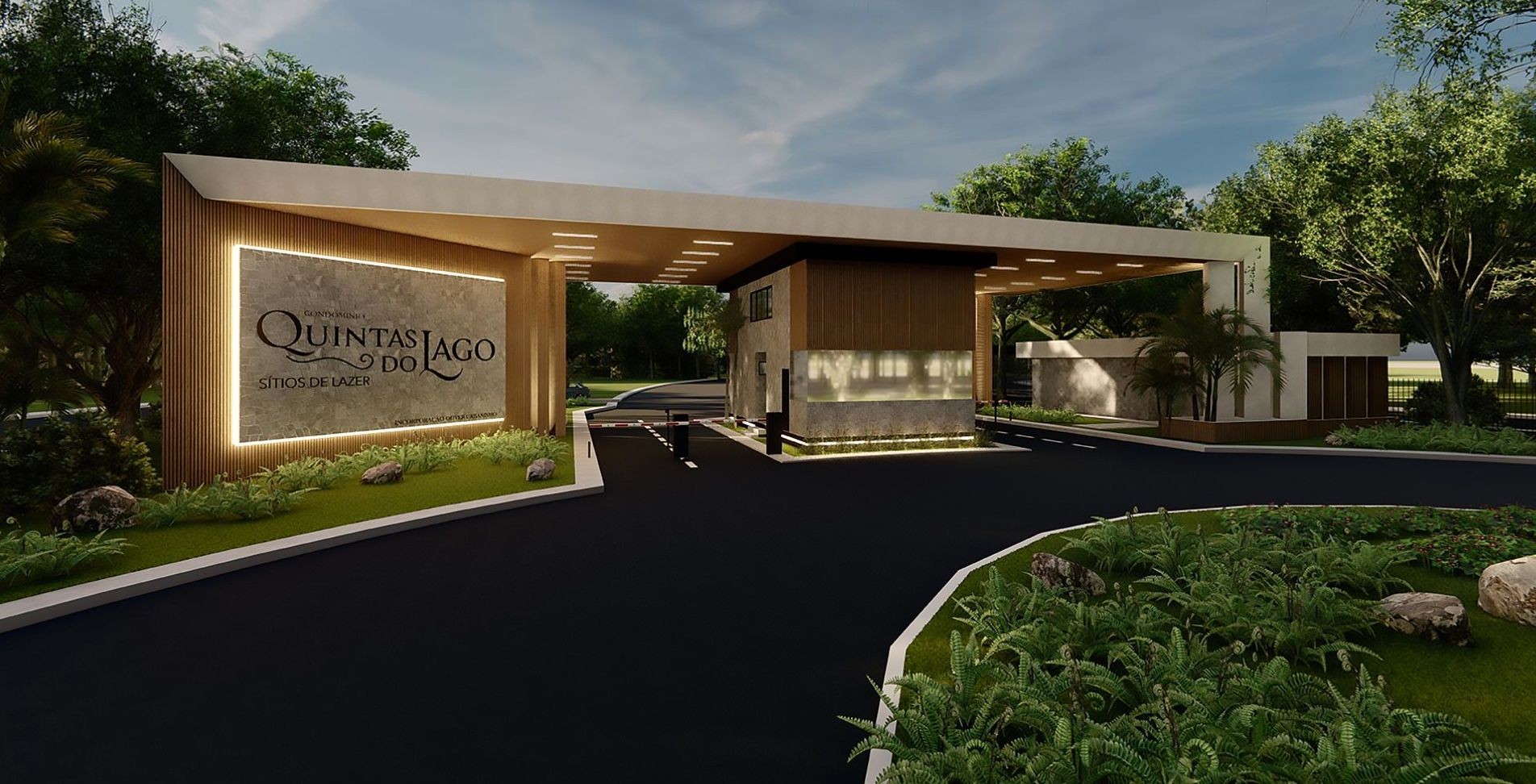 Entrance to Quintas do Lago, modern gated community surrounded by greenery and featuring sleek architectural design.